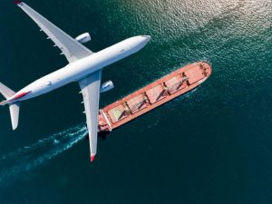 container ship sail through airplane flying on the sea